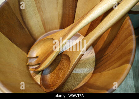 Wooden salad server spoon and fork in a wooden salad bowl Stock Photo
