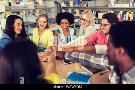 group of international students making fist bump Stock Photo