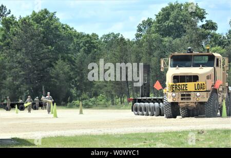 Wisconsin National Guard Soldiers conduct driver training June 19, 2019, at the parking area at Big Sandy Lake on South Post at Fort McCoy, Wis. The activity was part of annual training by Wisconsin National Guard troops at Fort McCoy in early June. Thousands of transient training troops trained at the installation in June 2019. (U.S. Army Photo by Scott T. Sturkol, Public Affairs Office, Fort McCoy, Wis.) Stock Photo