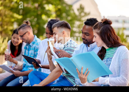 group of happy students with notebooks and drinks Stock Photo