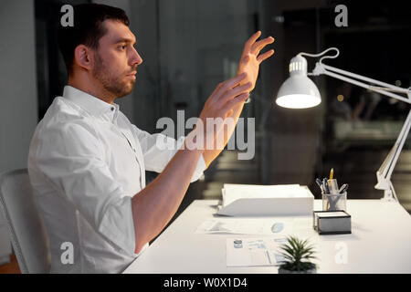 businessman using gestures at night office Stock Photo
