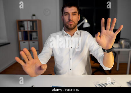 businessman using gestures at night office Stock Photo