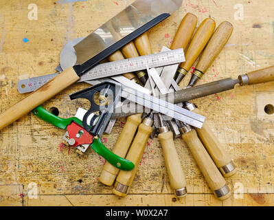 Various woodworking hand tools on aged wooden bench grunge surface. Stock Photo