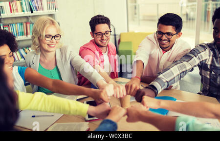 group of international students making fist bump Stock Photo