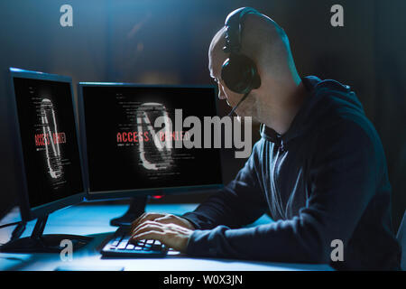 hacker with access denied messages on computers Stock Photo