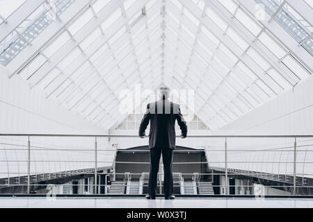 Serious elder man in big office centre Stock Photo