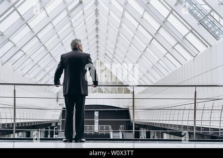 Serious elder man in big office centre Stock Photo