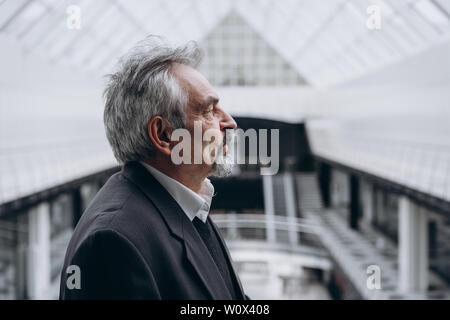 Serious elder man in big office centre Stock Photo