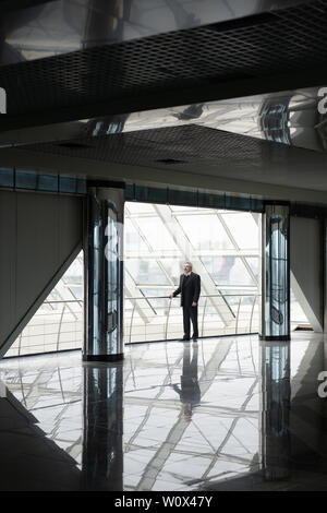 Serious elder man in big office centre Stock Photo
