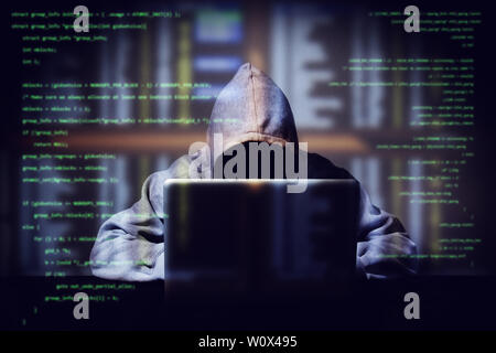 hacker working on a computer code with laptop, double exposure with digital interface around at background. internet crime , hacking and malware conce Stock Photo