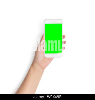 hand holding white mobile smart phone with blank green screen isolated on white background with clipping path on green screen and background, studio s Stock Photo