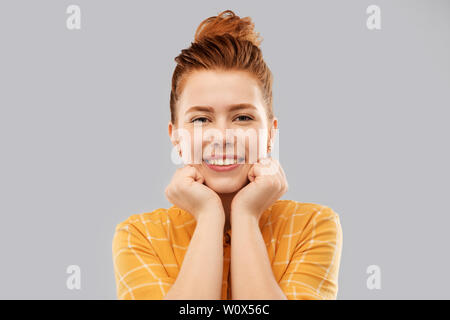 smiling red haired teenage girl in checkered shirt Stock Photo