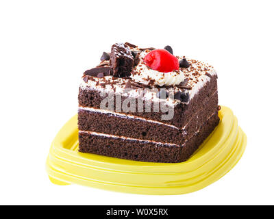 Chocolate cake is covered with whipped cream and decorated by red cherry on top Stock Photo