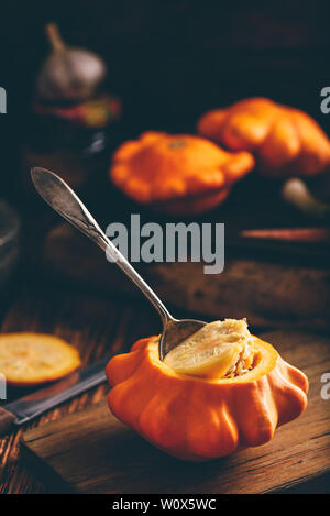 Preparing yellow pattypan squash for stuffing with minced meat Stock Photo