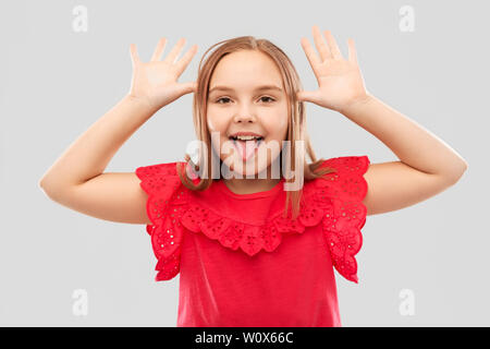funny girl showing her tongue and making big ears Stock Photo