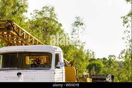 An old stairway truck abandoned and worn out by time, you see a front window without glass and steering wheel Stock Photo