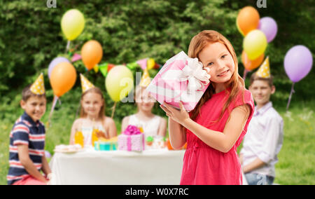 lovely red haired girl with birthday gift at party Stock Photo