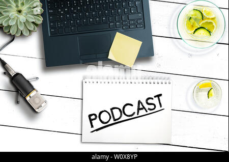 podcast recording concept, top view of laptop computer and microphone on rustic wooden table Stock Photo