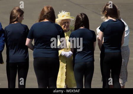 Cumbernauld, UK. 28 June 2019.  PICTURED: Her Majesty The Queen. On arrival at Greenfaulds High School, Her Majesty is met by the Lord Lieutenant of Dunbartonshire and the Lord Lieutenant of Lanarkshire before moving to the central atrium where a Gaelic welcome by senior pupils from the school. The Queen will be invited to view an exhibition and the headteacher, together with local historians, will explain the school’s history.  Credit: Colin Fisher/Alamy Live News Stock Photo