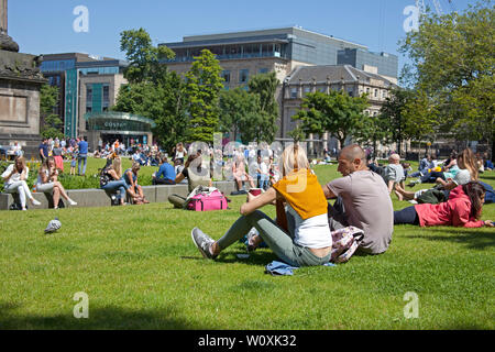 St Andrews Square Edinburgh, Scotland. 28th June 2019. Full sunshine in the city being enjoyed by office workers and visitors, 14 degrees in the morning with cool  wind increasing to 17 degrees in the afternoon allowing a relaxing lunch hour sunbathe. Stock Photo