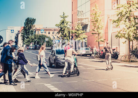 people crossing street at traffic light  - City traffic concept - Stock Photo