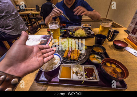 Tokyo - May 18, 2019: Travelers eating Gyukatsu beef in Akihabara in Tokyo, Japan Stock Photo