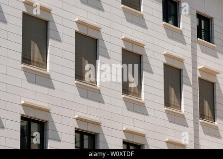 windows building facade with closed shutters / sun blinds - Stock Photo