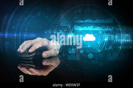 Hand using wireless mouse with cloud technology concept and dark background Stock Photo