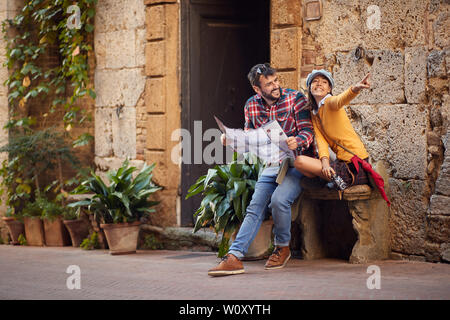 smiling couple with map and photo camera on the journey. Stock Photo