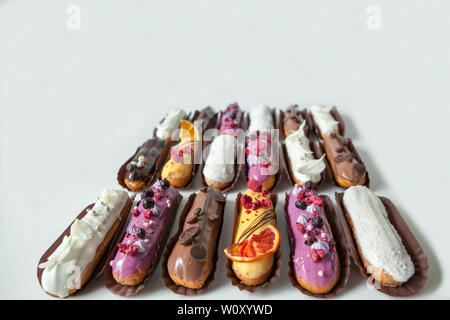 Set of several eclairs with various fillings and design isolate on a white background, the concept of French cuisine, copyspace Stock Photo