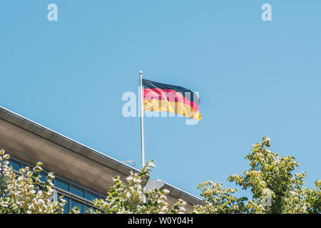 german flag on pole on building - national flag of Germany Stock Photo