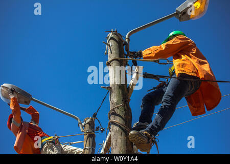 Electrician doing maintenance of street lamps in Africa. Stock Photo
