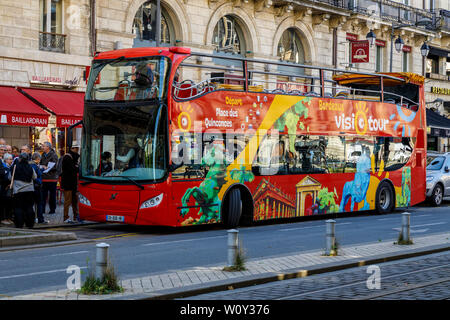 Red open topped Hop-On Hop-Off tourist bus in the city of Bordeaux, in the Gironde department in Southwestern France. Stock Photo