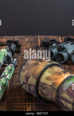 Equipment for the observation and photography of wild fauna on a rustic wooden table Stock Photo