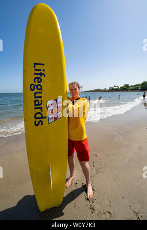 Aberdour, Fife, Scotland, UK. 28 June, 2019. Lifeguard Anna Whyte from Kinghorn in Fife was kept busy at Silver Sands Beach at Aberdour as warm weather and sunshine attracted dozens of people to the seaside. When she is not on duty as a lifeguard , Anna is also a volunteer with the local RNLI lifeboat. Credit: Iain Masterton/Alamy Live News Stock Photo