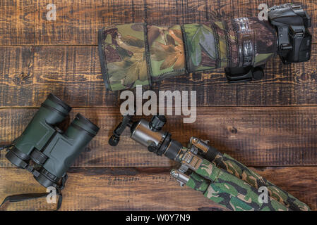 Equipment for the observation and photography of wild fauna on a rustic wooden table Stock Photo
