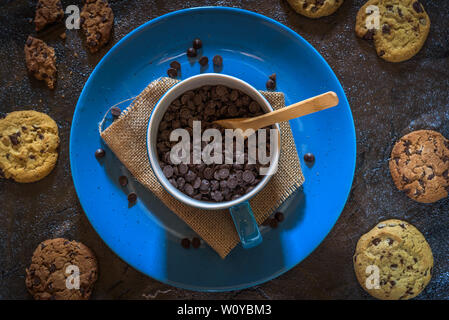 Bowl with chocolate chips and cookies around Stock Photo