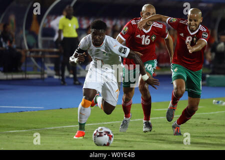 Cairo, Egypt. 28th June, 2019. Ivory coast's Serge Aurier (L), Morocco's Nordin Amrabat (C) and Karim El Ahmadi battle for the ball during the 2019 Africa Cup of Nations Group D soccer match between Morocco and Ivory coast at Al-Salam Stadium. Credit: Omar Zoheiry/dpa/Alamy Live News Stock Photo