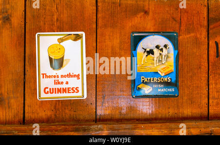 Old Irish metal advertising plates for Guinness beer and Paterson matches. Stock Photo