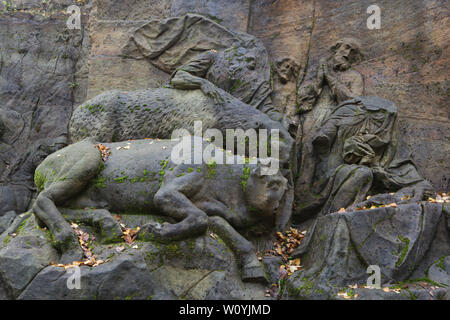 Cow and donkey depicted in the detail of the abandoned relief 'Nativity of Jesus' in the area of the open air sculptural gallery known as the Braunův Betlém (Braun's Bethlehem) in the forest near the village of Žireč in East Bohemia, Czech Republic. The monumental relief was carved by famous Austrian-born sculptor Matthias Bernhard Braun (Matyáš Bernard Braun) from 1726 to 1734 among other statues and relieves directly in sandstone rocks in the New Forest near the Kuks Hospital (Nový les u Kuksu). The Braunův Betlém is considered to be one of the masterpieces of Bohemian Baroque sculpture. Stock Photo