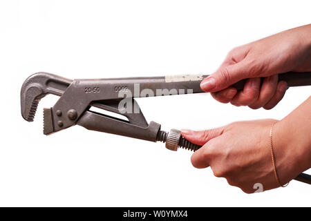 Girl holding a plumbing key isolated on a white background. Stock Photo