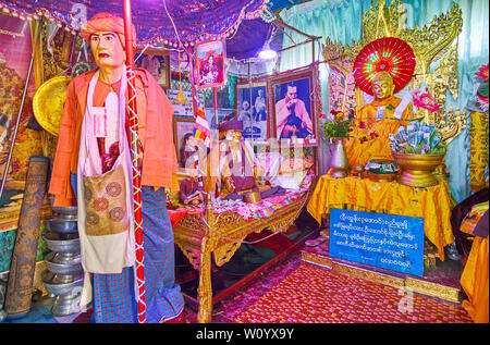 POPA, MYANMAR - FEBRUARY 26, 2018: Interior of Nat shrine of Popa Taung Kalat monastery with statues of Spirit deities, portraits, gilt carvings and d Stock Photo