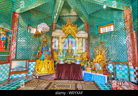 POPA, MYANMAR - FEBRUARY 26, 2018:  The richly decorated Temple of Popa Taung Kalat monastery with golden Buddha images, mirror patterns on walls and Stock Photo