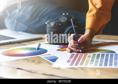 Close up hoto of Interior designers teamwork with house building plans on office desk Stock Photo