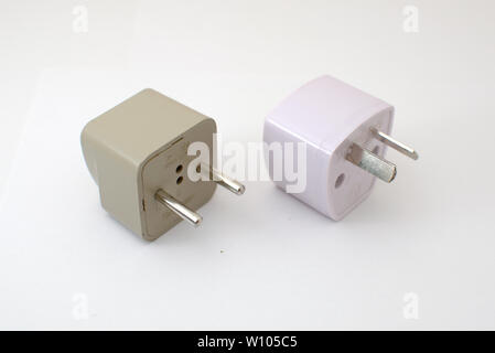 Studio shot of two adapter power plugs. Type C on the left, Argentinian type I on the right. Stock Photo