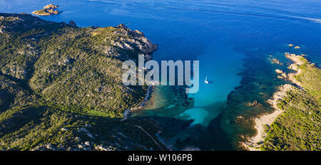 View from above, stunning aerial view of a sailing boat floating on a beautiful turquoise clear sea. Maddalena Archipelago National Park, Sardinia. Stock Photo