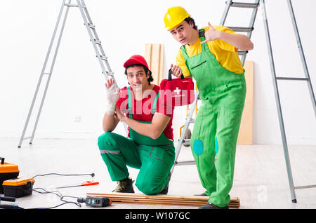 Injured worker and his workmate Stock Photo
