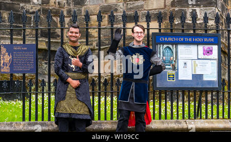 Young men dressed in period costume for tourists, Church Of the Holy Rude, Stirling Old Town, Scotland, UK Stock Photo