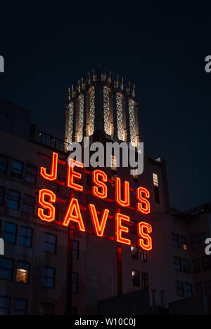 Jesus Saves sign at night, in downtown Los Angeles, California Stock Photo