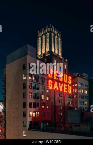 Jesus Saves sign at night, in downtown Los Angeles, California Stock Photo